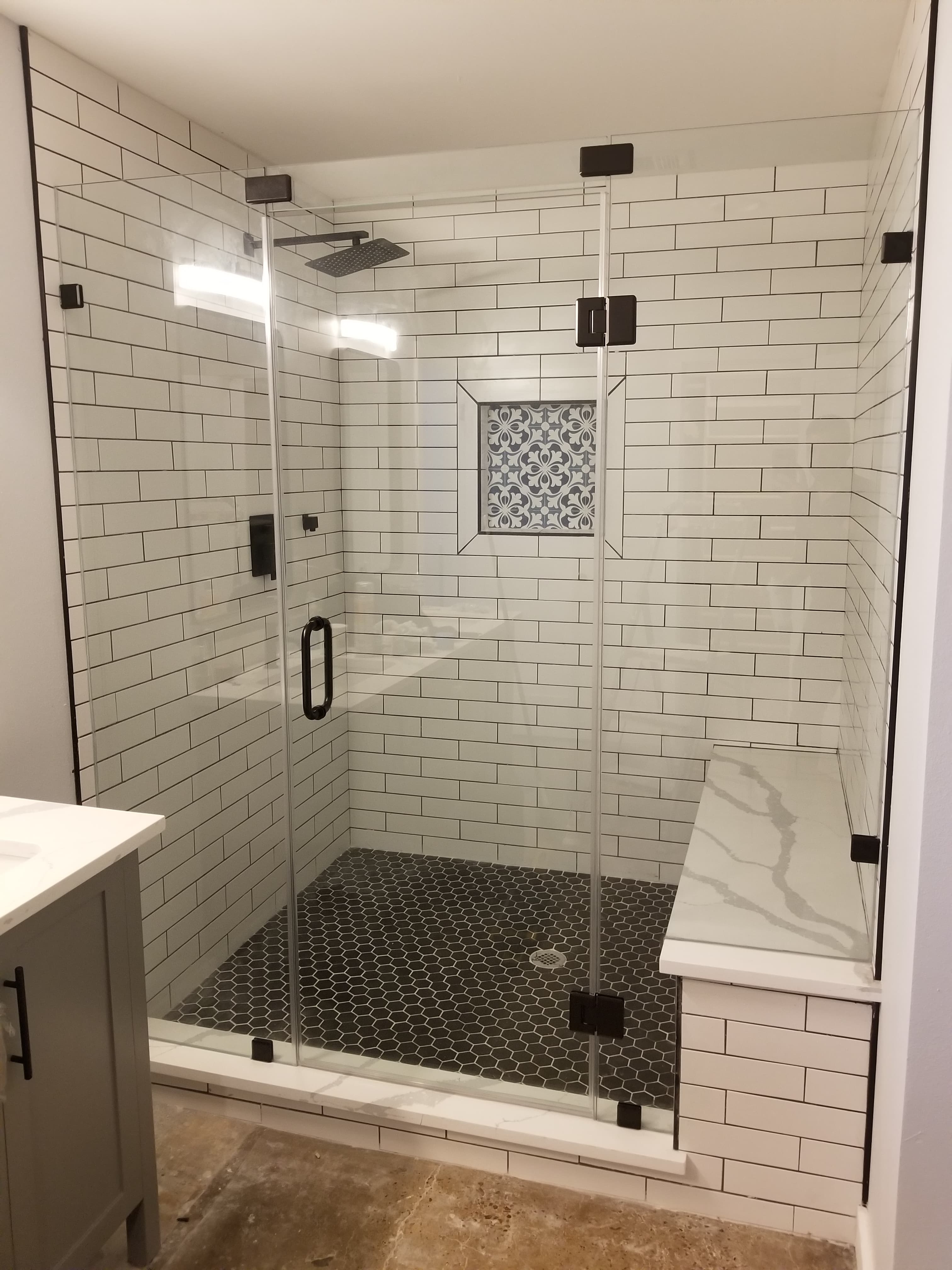 Frameless shower panel installed in a finished bathroom